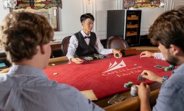 Elegant poker game at Cape La Cruz Poker Club, with players engaged around a luxurious table.