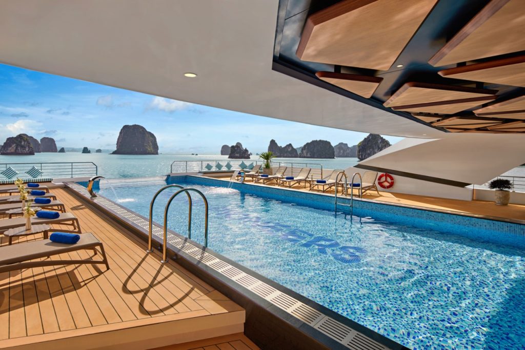Luxurious infinity pool with ocean view at a tropical resort.