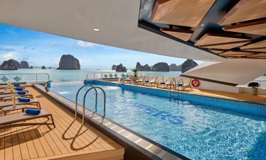 Luxurious infinity pool with ocean view at a tropical resort.