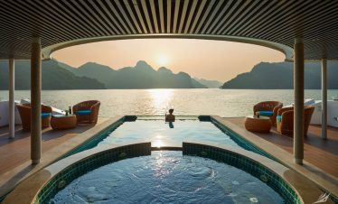 1. Luxurious infinity pool with stunning sunset over mountains and lake in Vietnam.