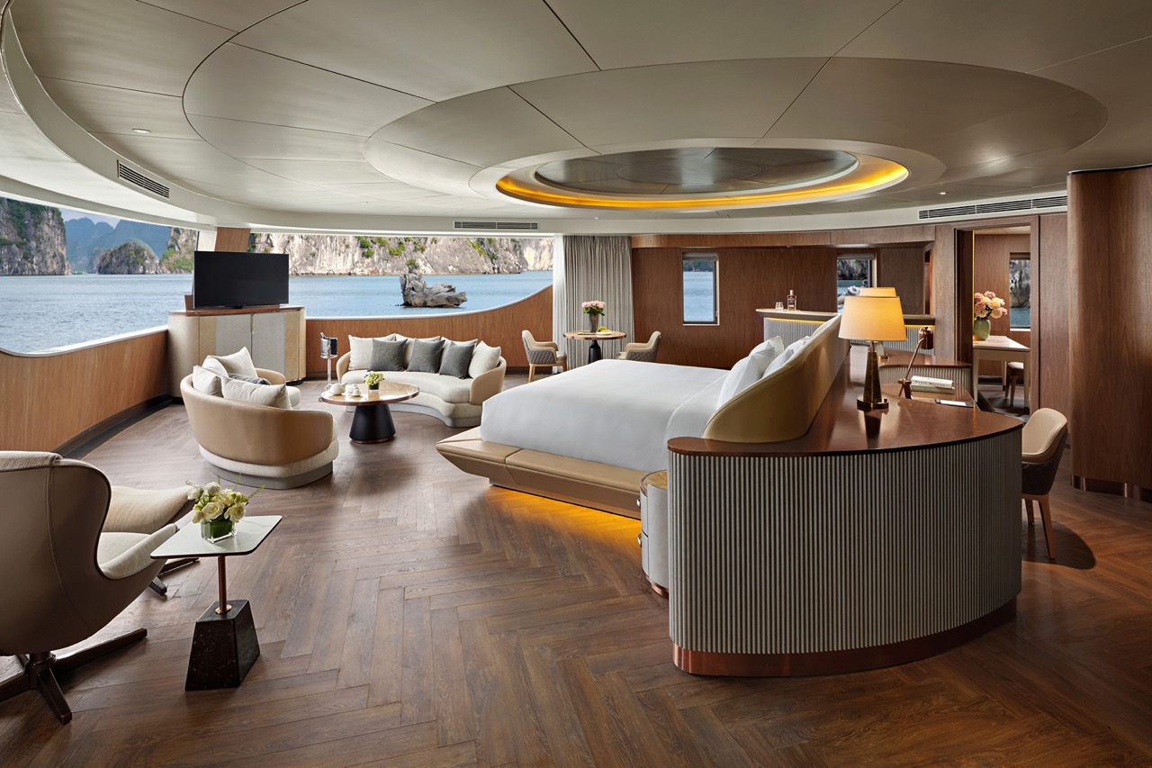 Luxury cruise cabin with ocean view, modern interior, and elegant furniture.