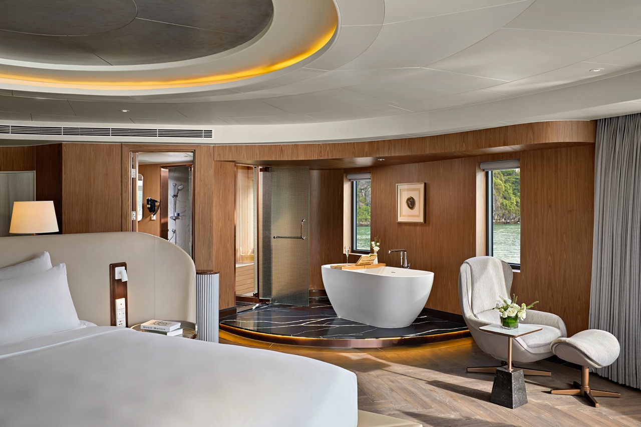 Luxurious hotel room with modern bathtub and scenic river views.