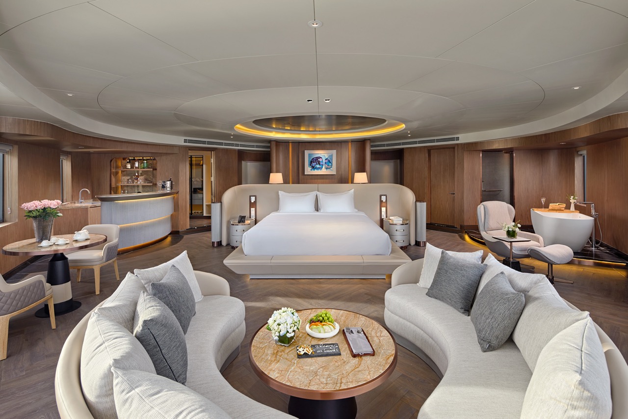 Luxurious modern hotel suite with stylish seating and elegant decor.