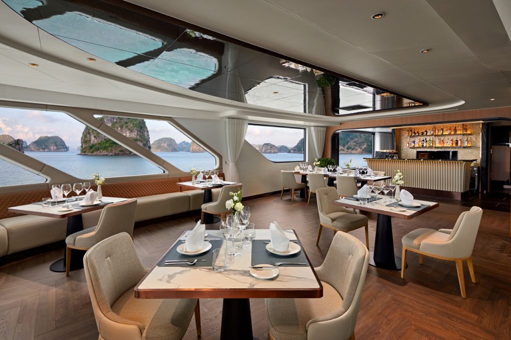 Luxurious onboard restaurant with panoramic sea views and elegant dining setup onboard a cruise ship.