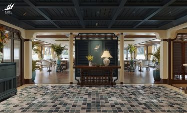Elegant hotel lobby with classic decor and lush plants for a luxurious travel experience.