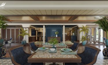 Elegant dining room at ViettrendTour resort with lush tropical plants and sea view decor.