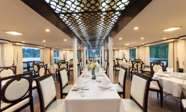 Luxurious restaurant interior with elegant dining setup and lake views.