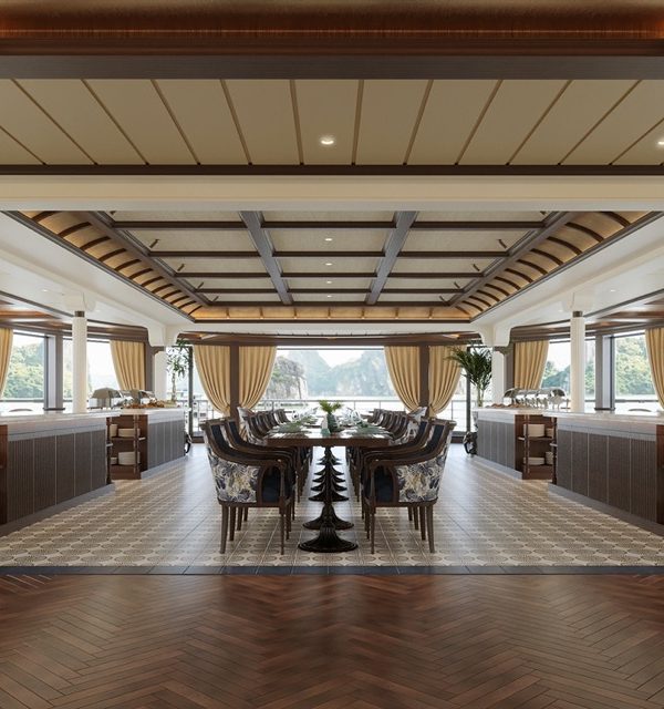 Luxurious waterfront restaurant with large windows and elegant decor.