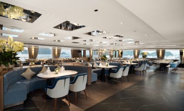 Elegant waterfront restaurant with luxurious furniture and ocean views in Vietnam.