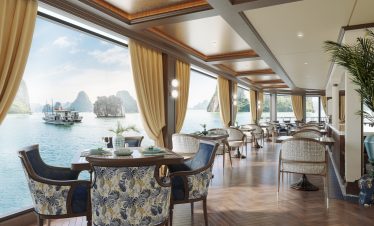 Elegant waterfront dining room with panoramic ocean views and luxurious decor at ViettrendTour.