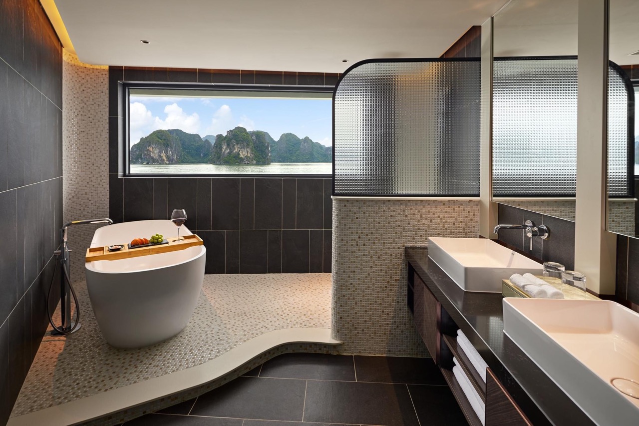 Luxurious bathroom with bathtub overlooking scenic karst mountain views in Vietnam.