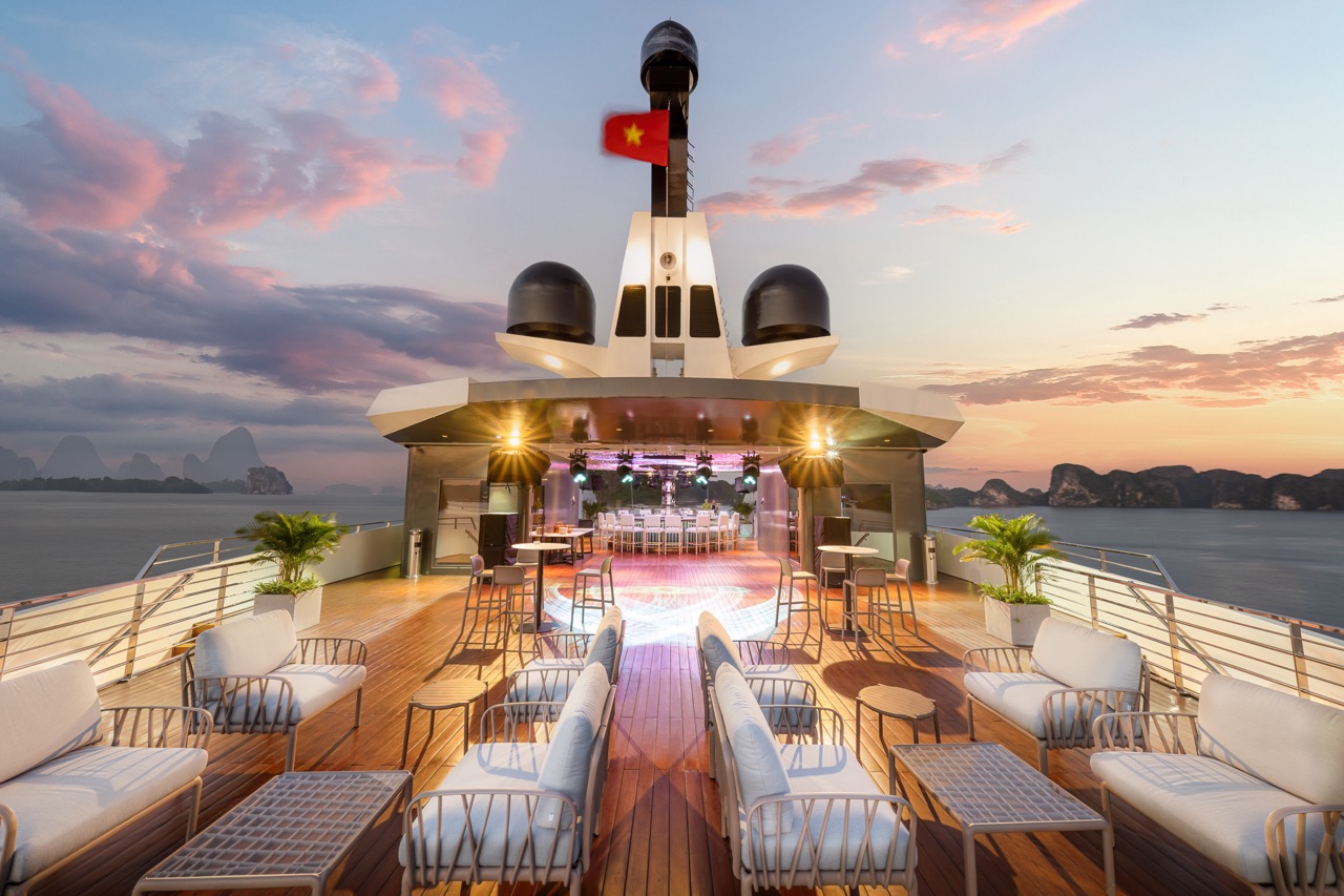 Luxurious yacht deck with sunset view in Vietnam, perfect for exclusive cruises and events.