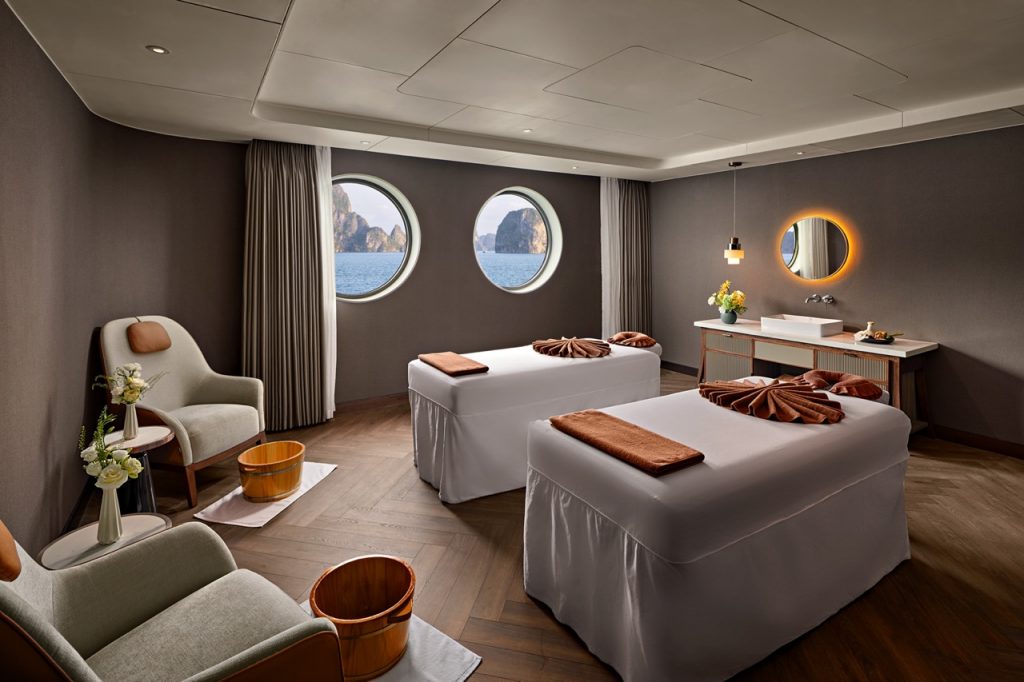 Luxurious spa room with ocean view, relaxing massage beds, modern decor, and tranquil ambiance for wellness retreats.