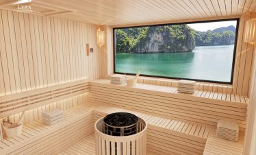 Tranquil wooden sauna room with large window overlooking tropical island scenery.