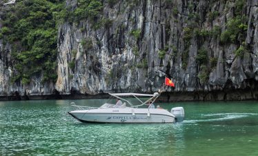 Relaxing boat cruise among limestone karsts in Halong Bay, Vietnam.