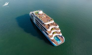 Luxury cruise ship with outdoor pools and panoramic decks for vacation travel.
