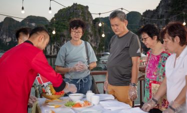 Fresh seafood cooking class with tourists at Halong Bay, Vietnam - authentic culinary experience.