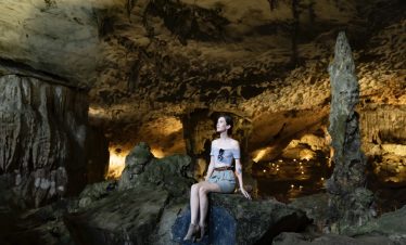 Magnificent woman exploring the stunning Son Doong Cave in Quang Binh, Vietnam.