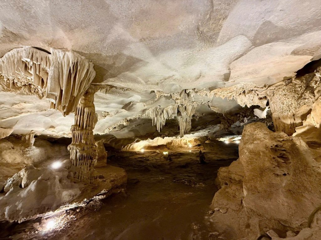 Stunning limestone cave with stalactites and stalagmites in a scenic underground tour.