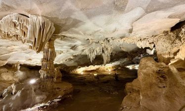 Stunning limestone cave with stalactites and stalagmites in a scenic underground tour.