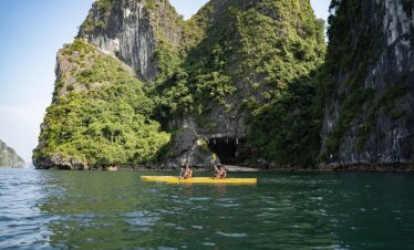 Lush green limestone islands with kayak adventure in Ha Long Bay, Vietnam.