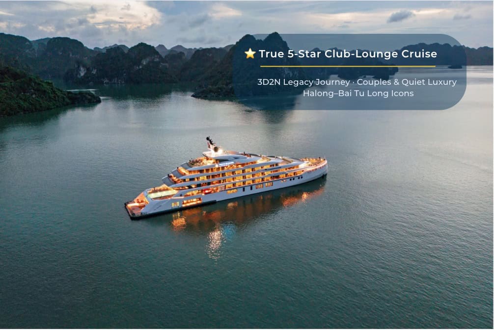 Luxury cruise boat in Halong Bay at sunset, offering 5-star yacht tours and scenic island visits.