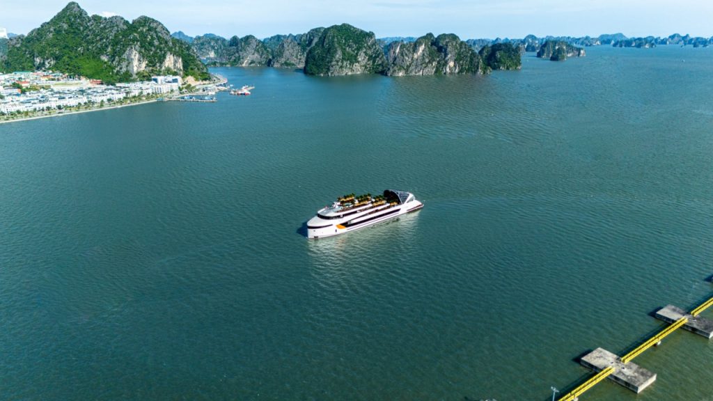 Luxury yacht cruising in Ha Long Bay, Vietnam with scenic limestone karsts.