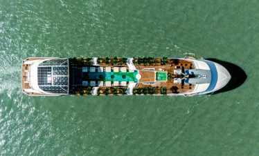 Luxurious yacht cruising in clear waters with a modern deck and hydrophilic amenities.