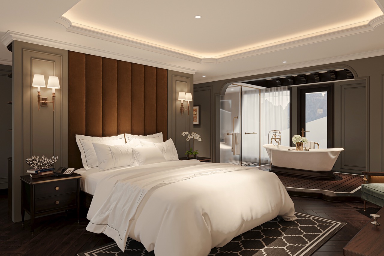 Luxurious hotel bedroom with elegant decor and a freestanding bathtub, perfect for a relaxing stay.