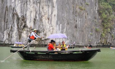 Serene boat tour on Halong Bay with limestone cliffs and emerald waters, perfect for travelers seeking adventure and nature.