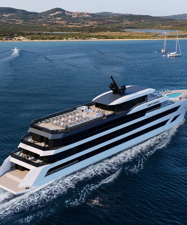 Luxurious yacht cruising in pristine blue waters with scenic coastline background.