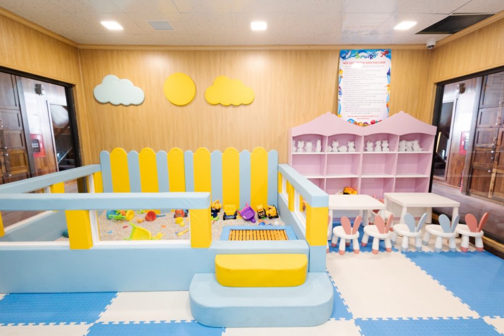 Colorful indoor children's play area with toys, soft flooring, and playful decor for kids' fun.