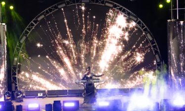 ViettrendTour fireworks celebration at night with vibrant stage lighting and performer.