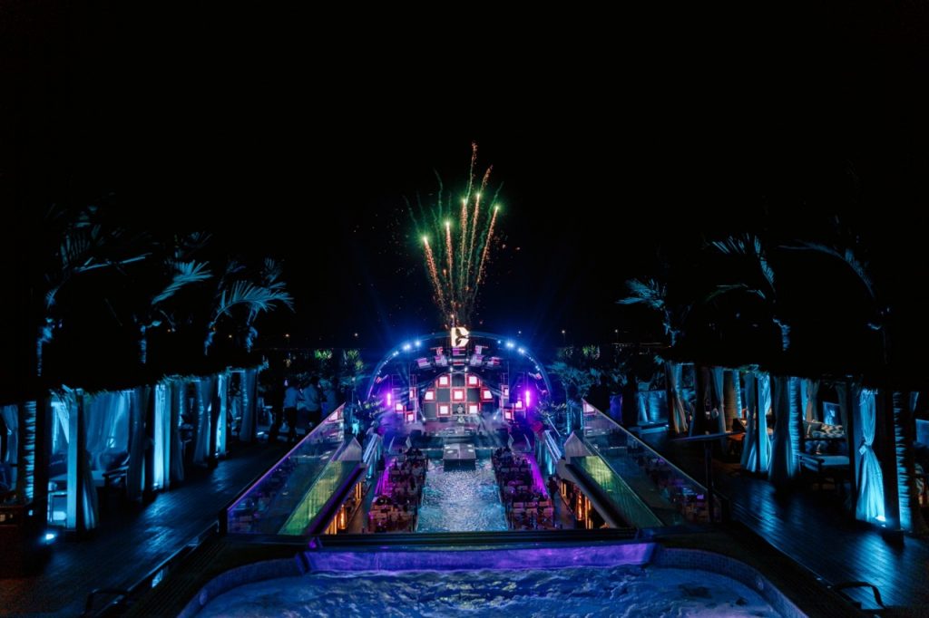 Vietnampool party with fireworks and vibrant lights at night.