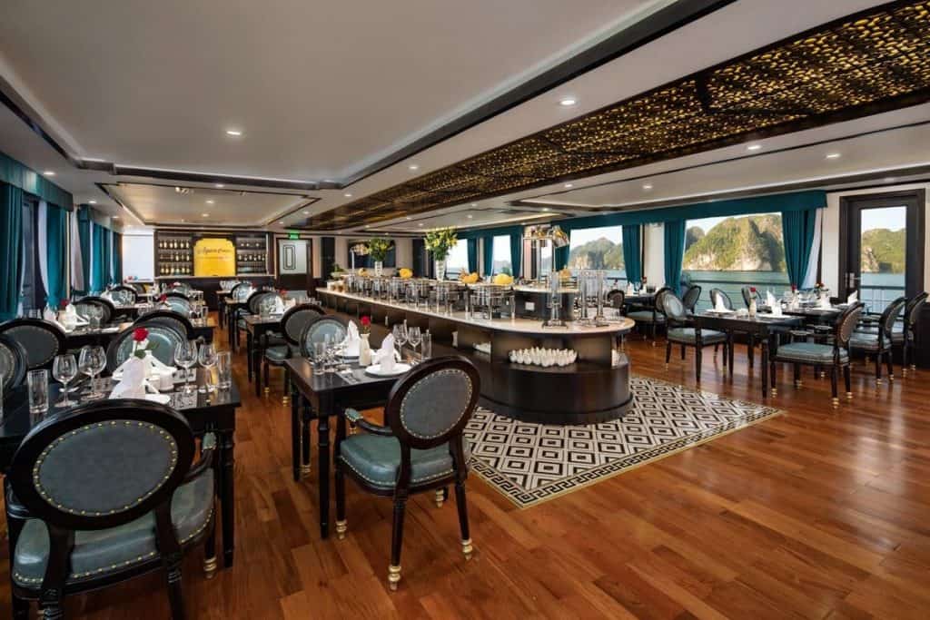 Elegant cruise ship dining room with ocean views and luxurious decor.