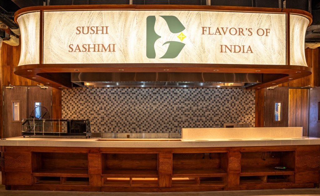 Fresh sushi and sashimi display at an Indian-themed restaurant in Vietnam, highlighting authentic flavors.