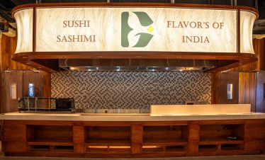 Fresh sushi and sashimi display at an Indian-themed restaurant in Vietnam, highlighting authentic flavors.