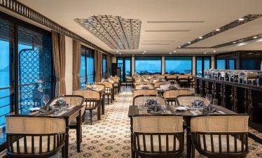 Elegant cruise dining room with ocean views on Venus Cruise Lan Ha Bay, perfect for a relaxing trave.