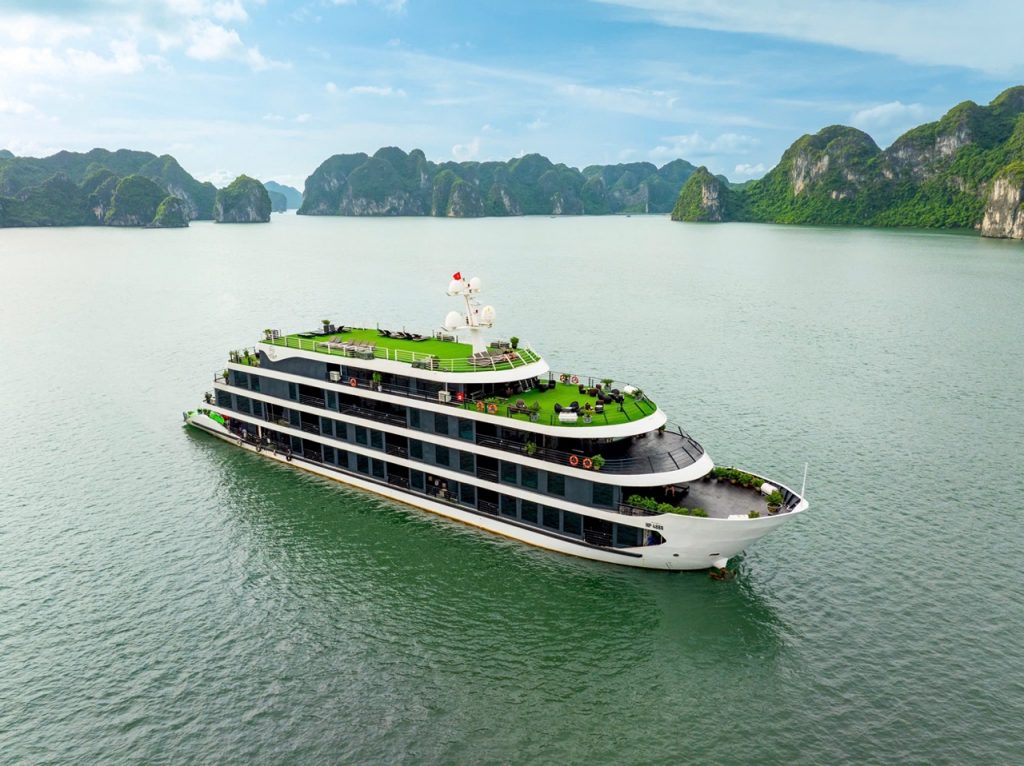 Lan Ha Bay Cruise 1 night - Luxurious cruise ship sailing through Lan Ha Bay with scenic limestone karsts.