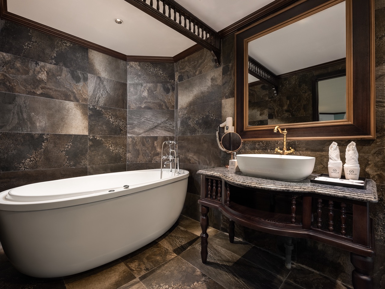 Elegant bathroom with bathtub and vanity on Halong Bay cruise, showcasing comfort and style in a sce.