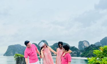 Scenic Lan Ha Bay cruise balcony with family, lush green islands, and calm waters, perfect for a rel.