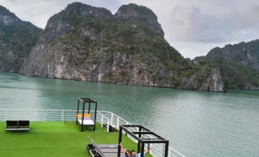 Lan Ha Bay scenic cruise balcony with limestone cliffs and tranquil waters, perfect for relaxing and.