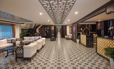 Spacious cruise lounge with elegant decor, comfortable seating, and ambient lighting, perfect for re.