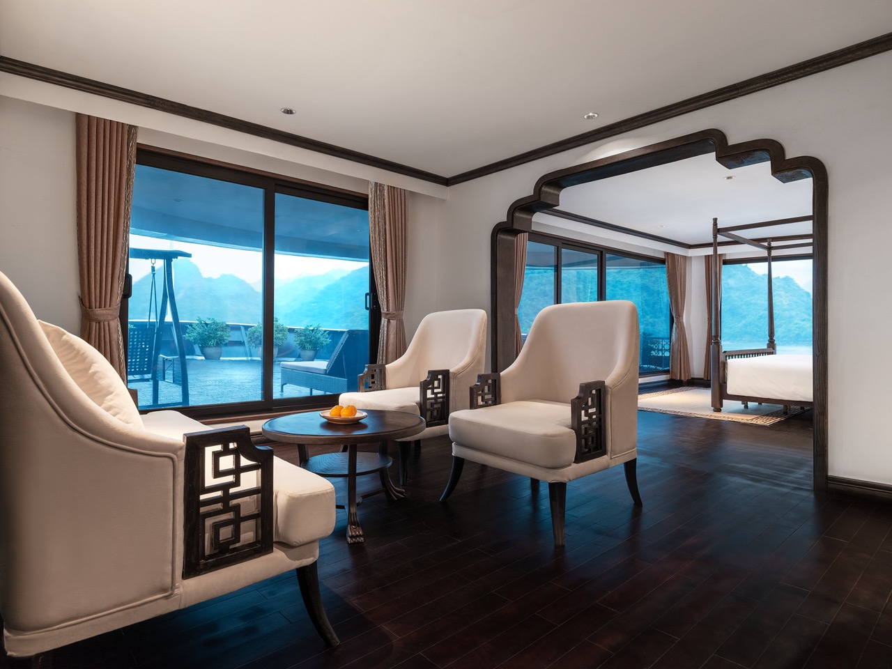 Scenic Lan Ha Bay cruise balcony scene showcasing tranquil waters and stunning mountain vistas.