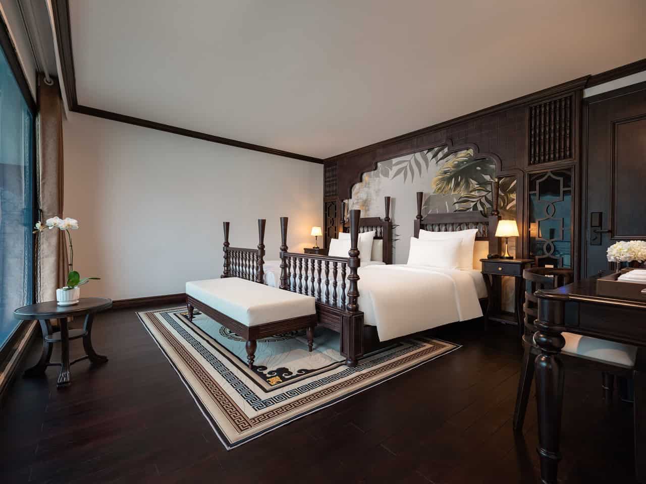 Elegant cruise cabin with luxurious decor and panoramic views of Lan Ha Bay, perfect for a relaxing.