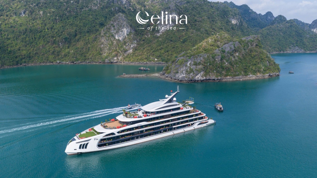 Large white luxury yacht cruising through turquoise water near green, rocky islands; Celina of the Sea logo above.