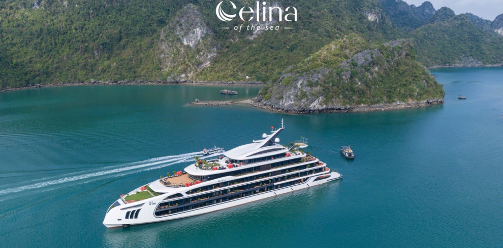 Large white luxury yacht cruising through turquoise water near green, rocky islands; Celina of the Sea logo above.