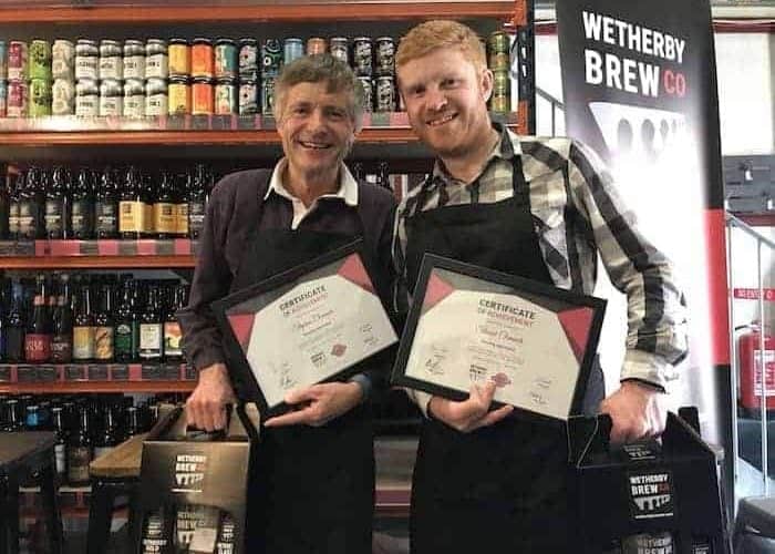 Wetherby Brew Co brewing experience guests holding a certificate