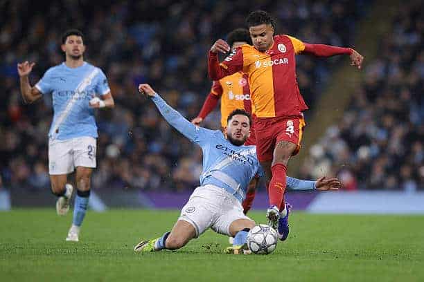 MANCHESTER, ENGLAND - JANUARY 28: Ismail Jakobs of Galatasaray SK is fouled by Rayan Cherki of Manchester City during the UEFA Champions League 2025/26 League Phase MD8 match between Manchester City and Galatasaray A.S. at City of Manchester Stadium on January 28, 2026 in Manchester, England. (Photo by James Gill - Danehouse/Getty Images)
