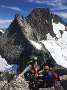 Climbers enjoy the summit of Forbidden Peak.